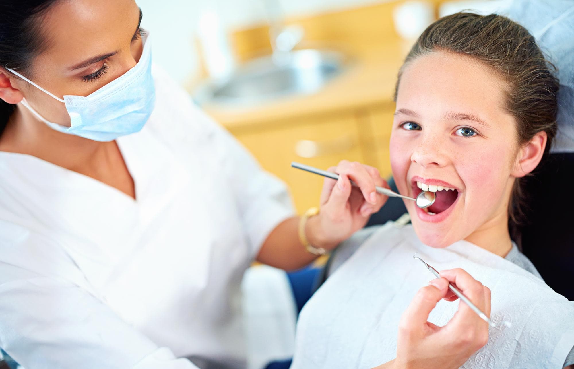 Young child smiling during an early orthodontic checkup
